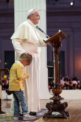 Pope Francis and child on stage