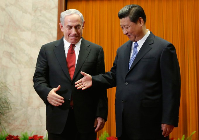 China's President Xi shakes hands with Israel's Prime Minister Netanyahu at the Great Hall of the People in Beijing